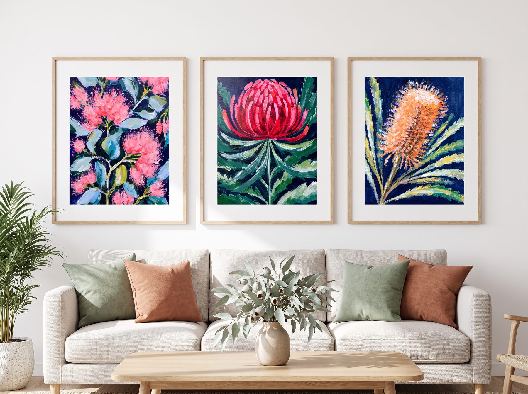 Three vivid Australian botanical prints above a linen sofa
